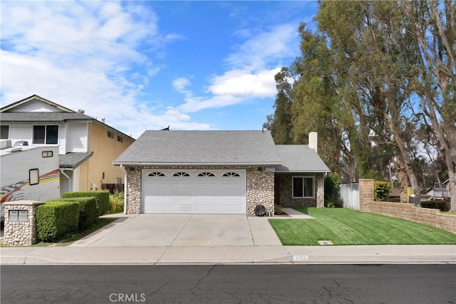 view of front of property with an attached garage, brick siding, fence, driveway, and a front yard