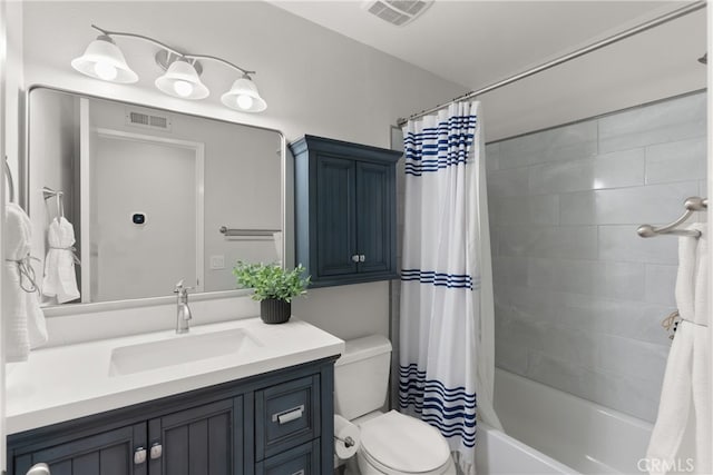 bathroom featuring toilet, shower / tub combo, vanity, and visible vents