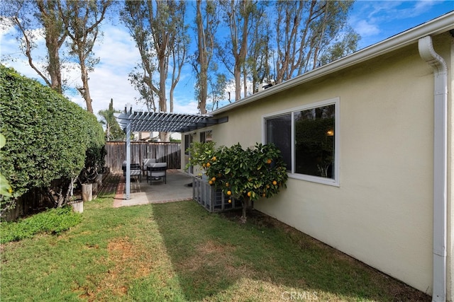 view of yard featuring a patio area, fence, and a pergola