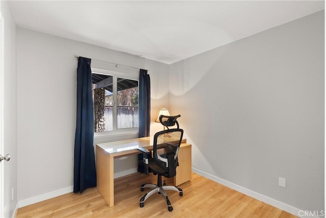 office with baseboards and wood finished floors