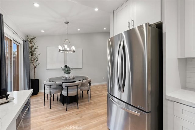 kitchen featuring light wood-style floors, freestanding refrigerator, white cabinets, and recessed lighting