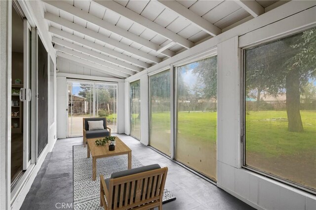 sunroom featuring vaulted ceiling with beams