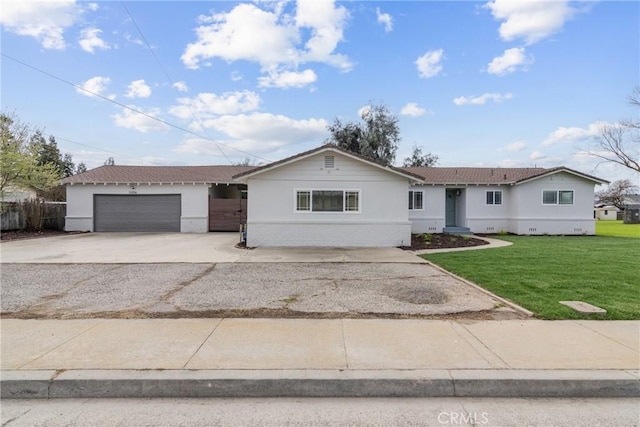 ranch-style home featuring a garage, concrete driveway, fence, a front yard, and brick siding