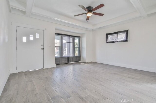 interior space featuring ceiling fan, wood finished floors, and baseboards