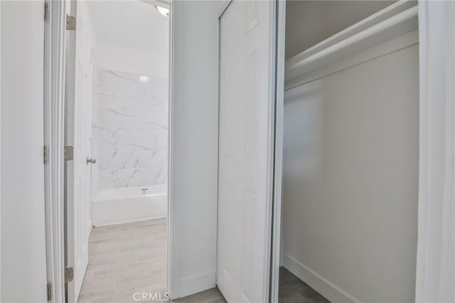 bathroom featuring wood finished floors and baseboards