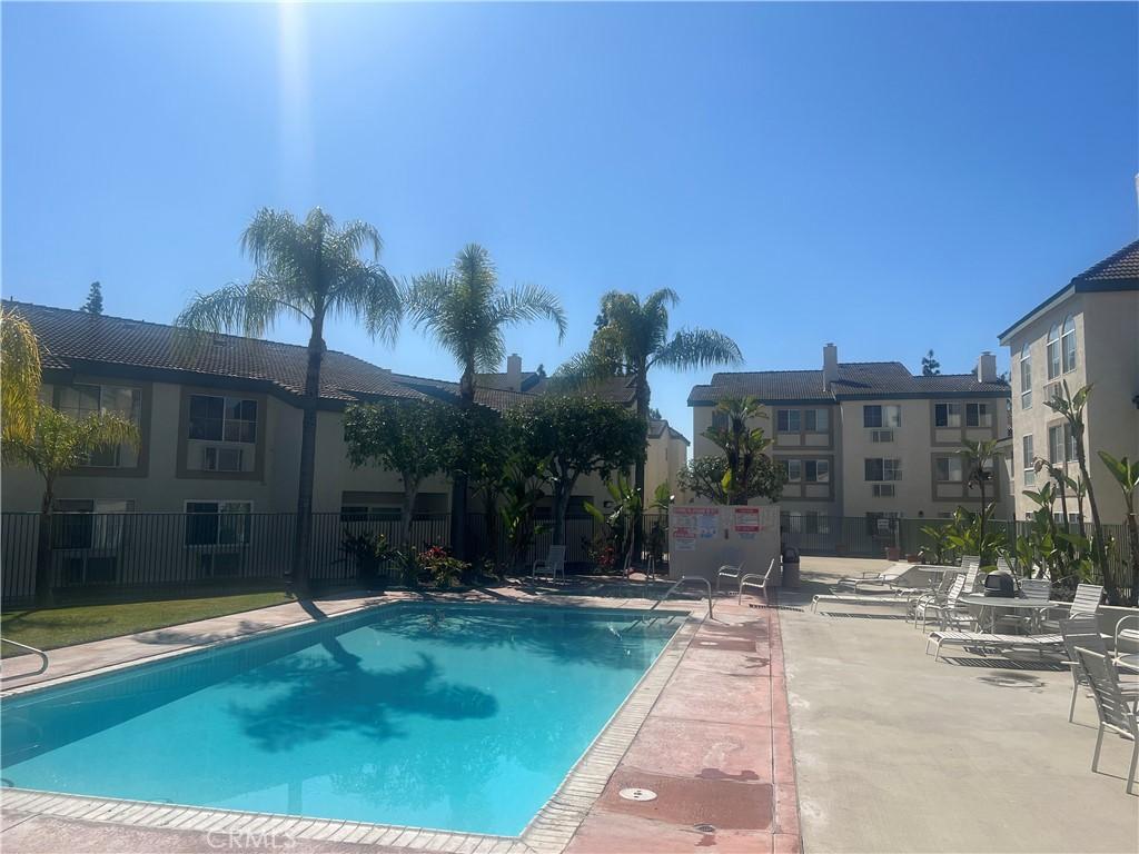 pool with a patio and fence