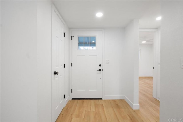 doorway featuring recessed lighting, light wood-type flooring, and baseboards