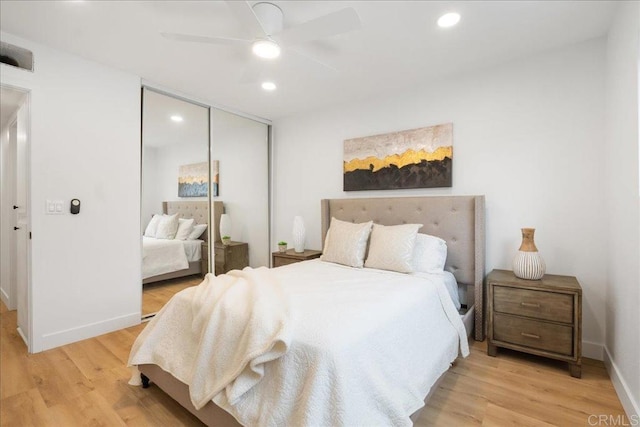 bedroom with recessed lighting, a closet, light wood-style flooring, ceiling fan, and baseboards