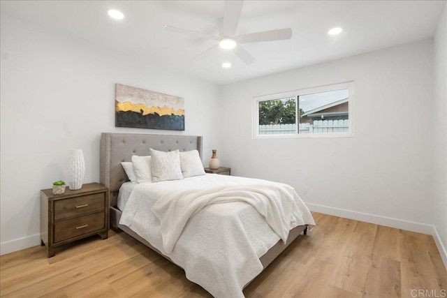 bedroom featuring baseboards, light wood finished floors, and recessed lighting