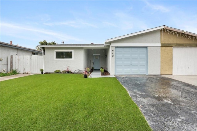 ranch-style home featuring a garage, fence, driveway, stucco siding, and a front yard