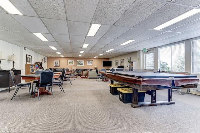 recreation room featuring carpet and a drop ceiling