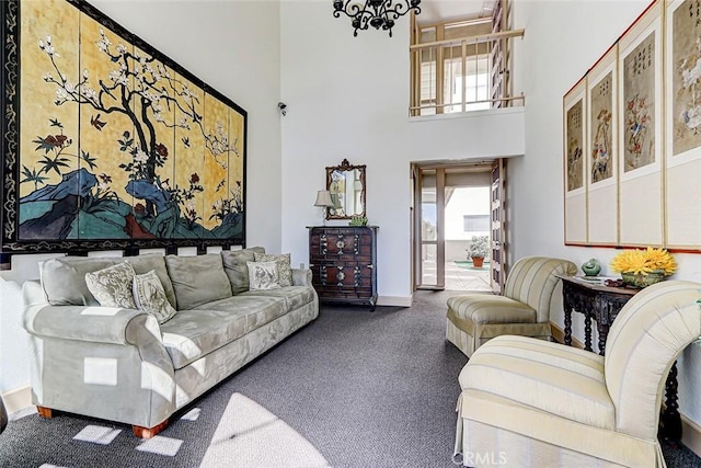 carpeted living area featuring a towering ceiling