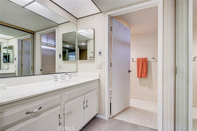 bathroom with vanity and baseboards