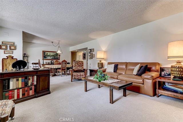 living room featuring light colored carpet and a textured ceiling