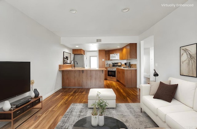 living room with dark wood finished floors, visible vents, recessed lighting, and baseboards