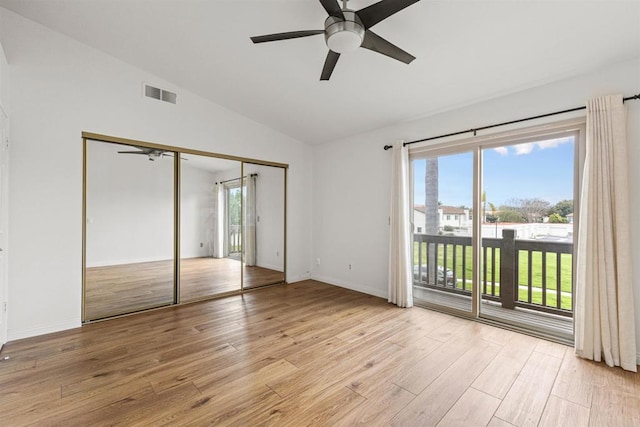 unfurnished bedroom featuring baseboards, visible vents, light wood finished floors, access to exterior, and vaulted ceiling