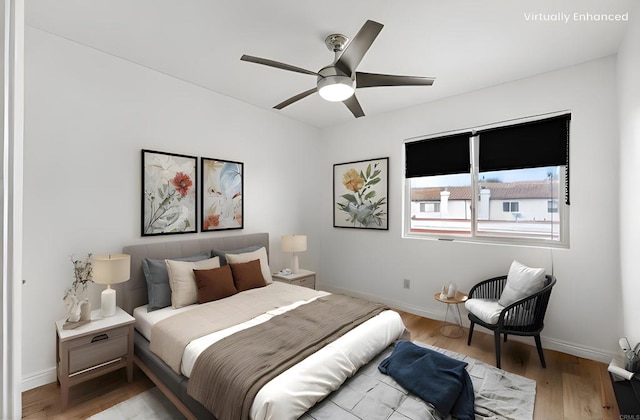 bedroom featuring wood finished floors, baseboards, and ceiling fan