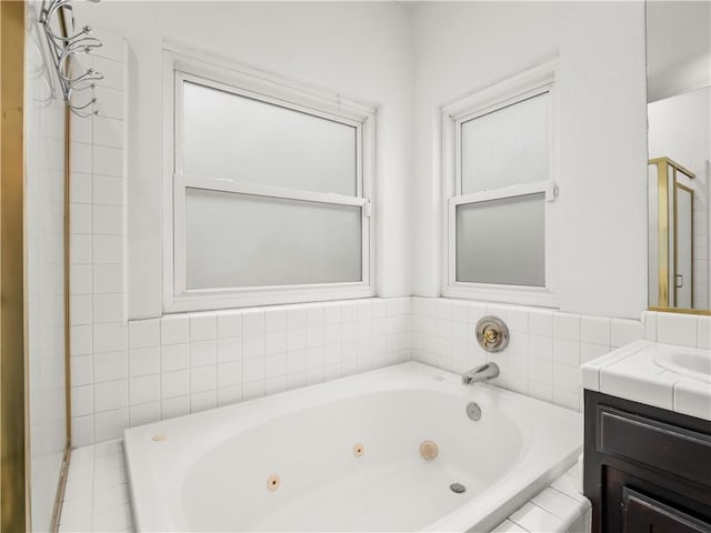 full bathroom with a whirlpool tub and vanity