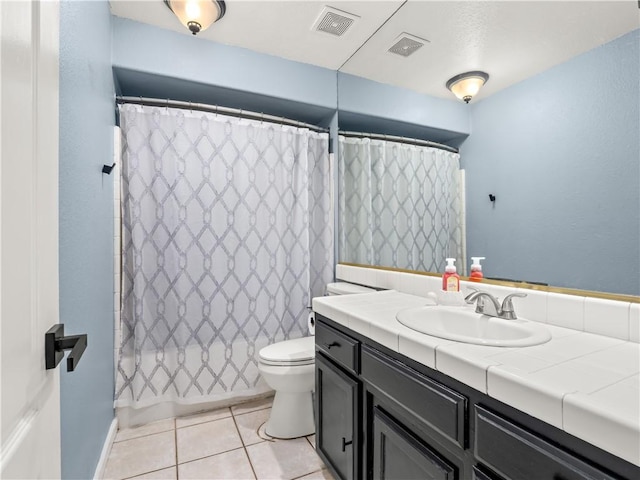 full bathroom featuring toilet, vanity, visible vents, and tile patterned floors