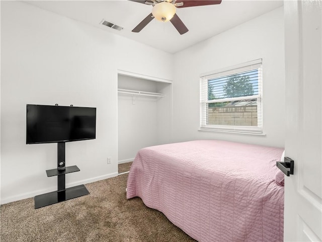 carpeted bedroom with baseboards, visible vents, ceiling fan, and a closet