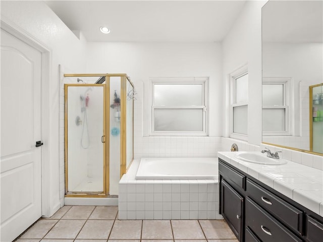 bathroom featuring a garden tub, tile patterned flooring, vanity, and a stall shower