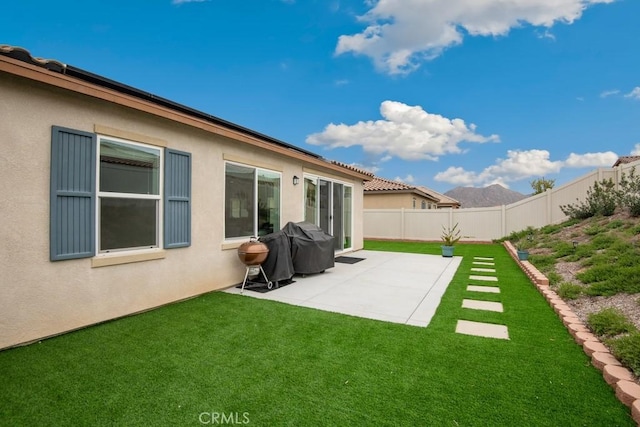 view of yard featuring fence and a patio