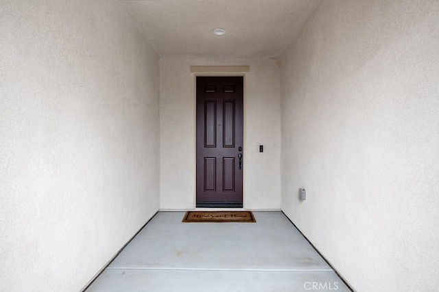 entrance to property with stucco siding