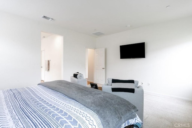 carpeted bedroom with visible vents and baseboards