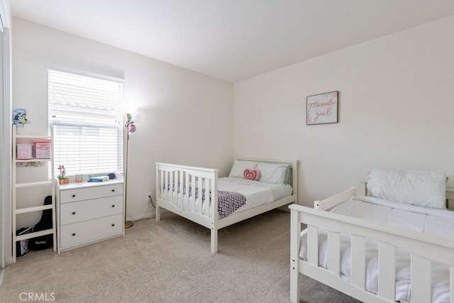 bedroom featuring light carpet