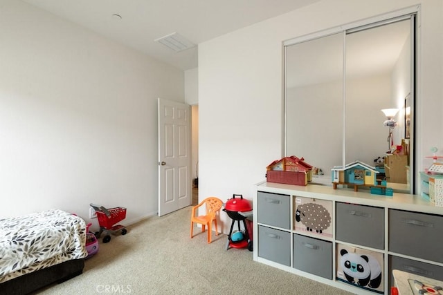 bedroom with visible vents and carpet flooring