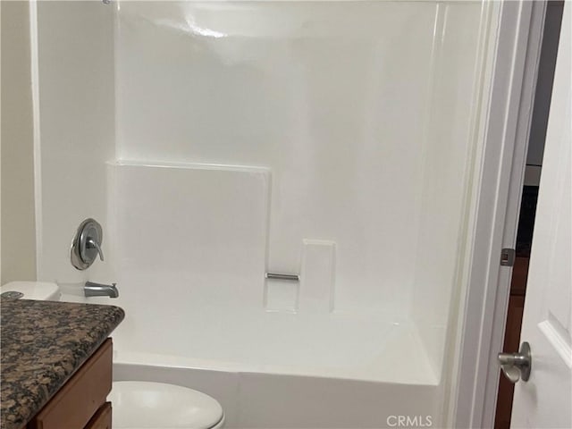 bathroom featuring toilet, tub / shower combination, and vanity