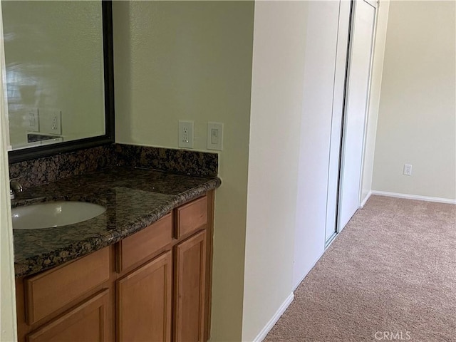 bathroom with baseboards and vanity