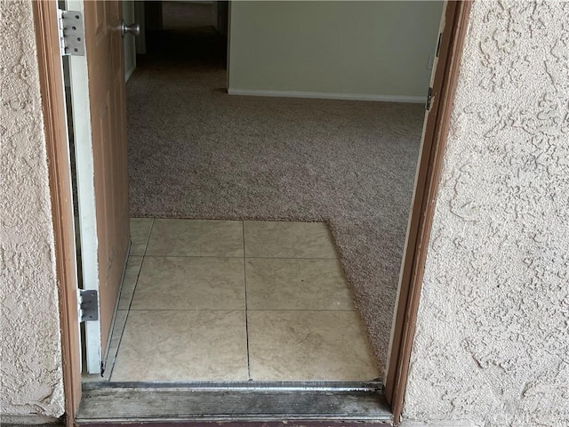 interior space with carpet flooring and baseboards