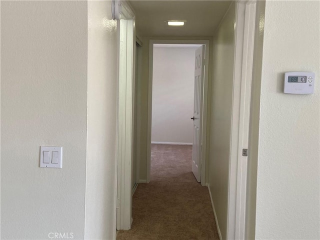 corridor featuring carpet floors and baseboards