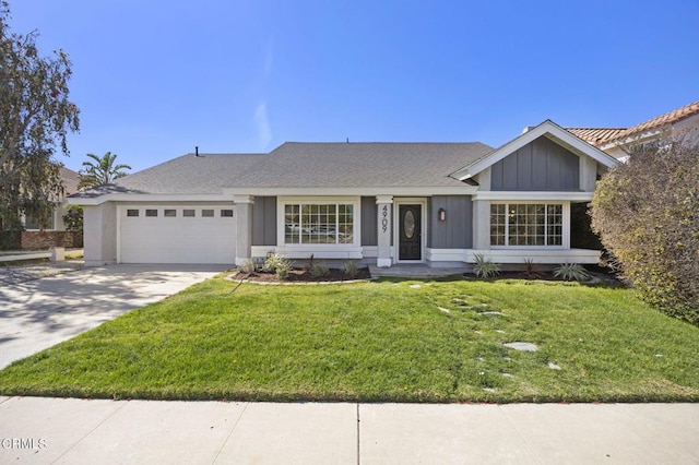 ranch-style house featuring a garage, concrete driveway, board and batten siding, and a front yard