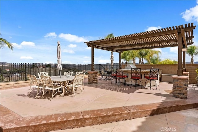 view of patio / terrace with outdoor dry bar, fence, outdoor dining area, exterior kitchen, and a pergola