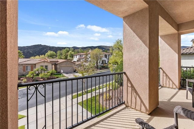 balcony with a residential view and a mountain view