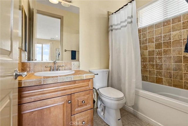 bathroom featuring a wealth of natural light, tile patterned flooring, vanity, and toilet