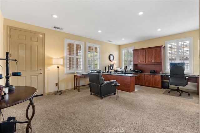 office featuring recessed lighting, light colored carpet, visible vents, and baseboards