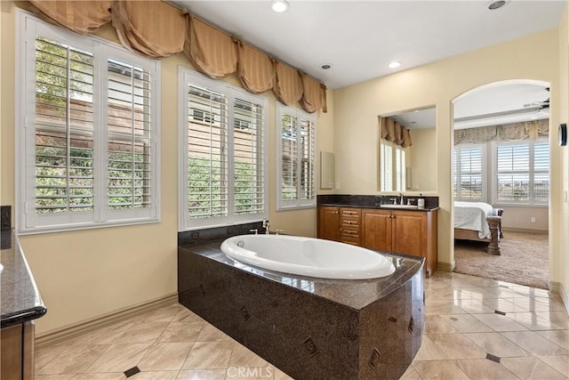 ensuite bathroom featuring a garden tub, recessed lighting, ceiling fan, vanity, and tile patterned floors