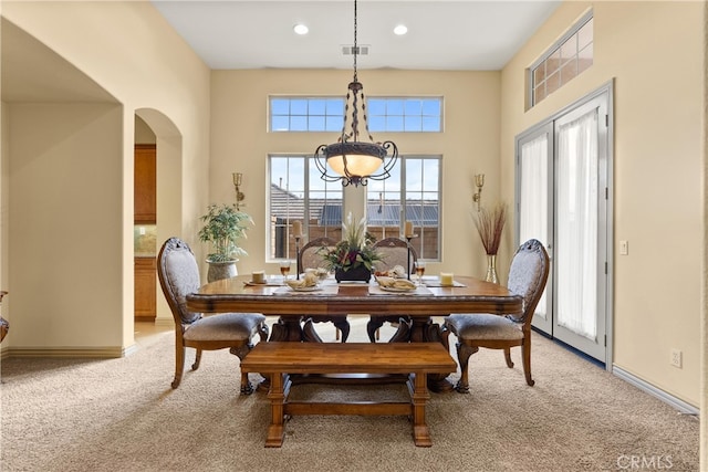 8072 Soft Winds Dr, Corona, CA 92883 - dining room featuring light carpet, arched walkways, recessed lighting, and a chandelier