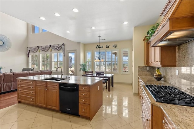 kitchen featuring a wealth of natural light, a sink, custom exhaust hood, and black appliances