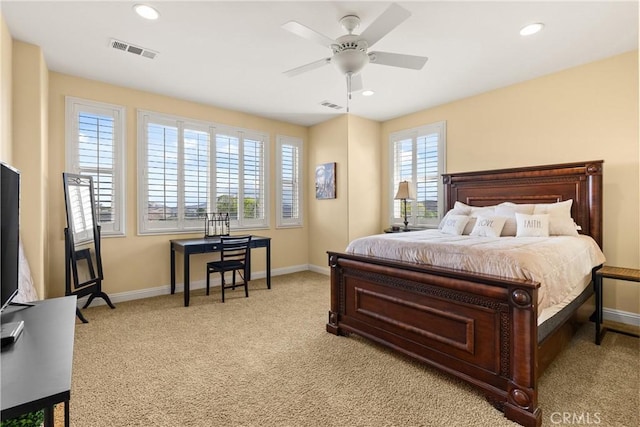 bedroom featuring visible vents, light carpet, and baseboards