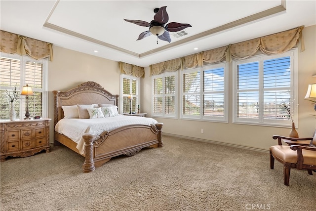 bedroom featuring carpet, visible vents, and a tray ceiling