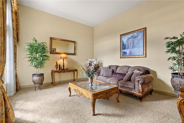 living area featuring carpet and baseboards