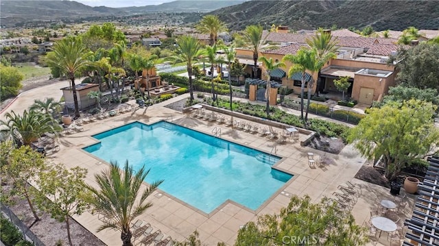 pool with a patio and a mountain view