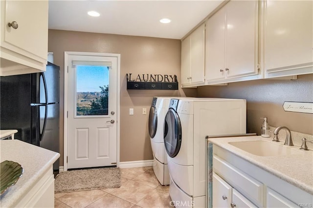 laundry room with light tile patterned floors, recessed lighting, separate washer and dryer, a sink, and cabinet space