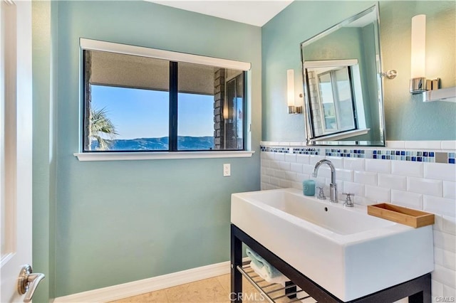 bathroom with tile patterned floors, baseboards, tile walls, and vanity