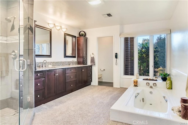 full bathroom with toilet, a shower stall, visible vents, and a sink