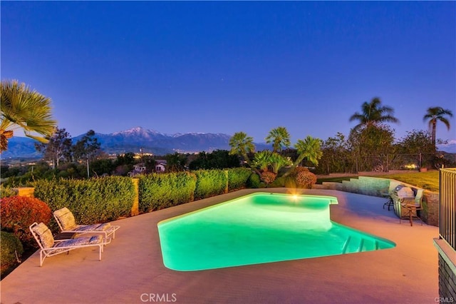 outdoor pool featuring a mountain view and a patio